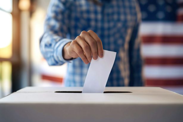 Person Depositing Voting Paper in Ballot Box at Election. EEUU.